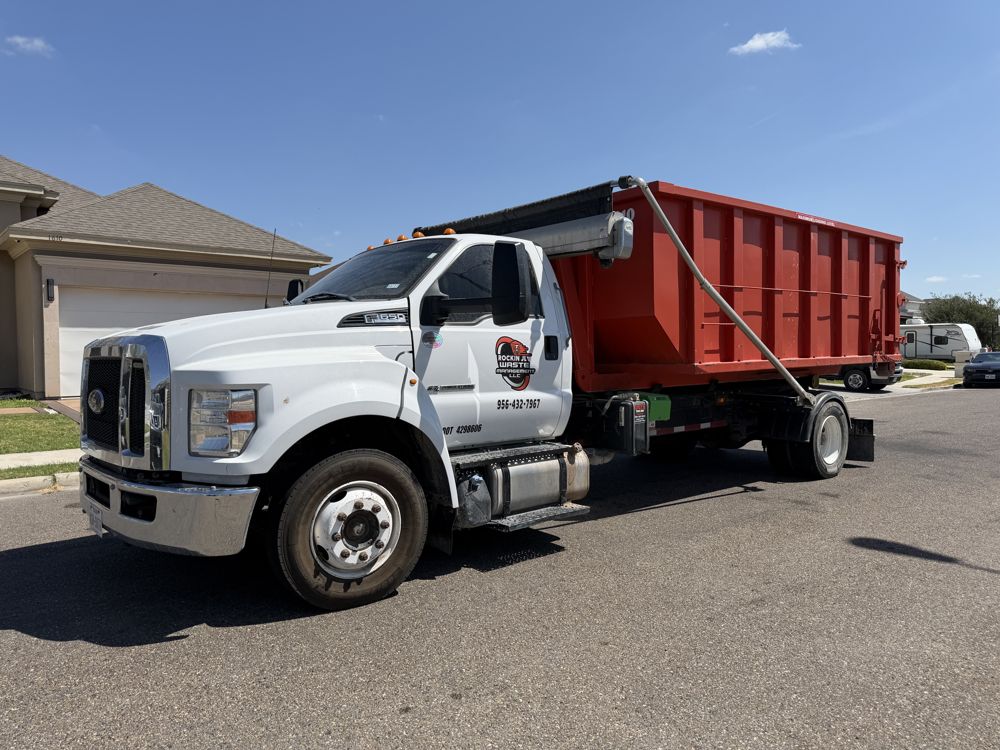 Rockin JL truck delivering a dumpster in a residential neighborhood